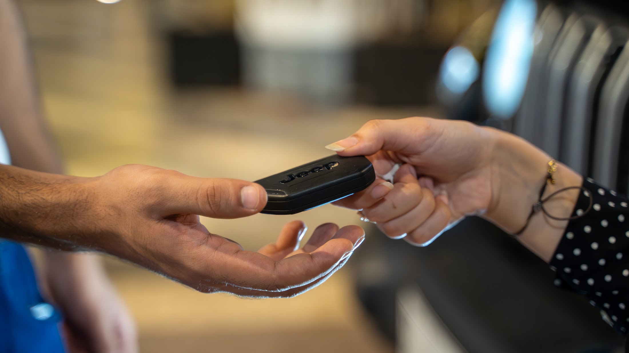 A VPM valet returning keys to a guest