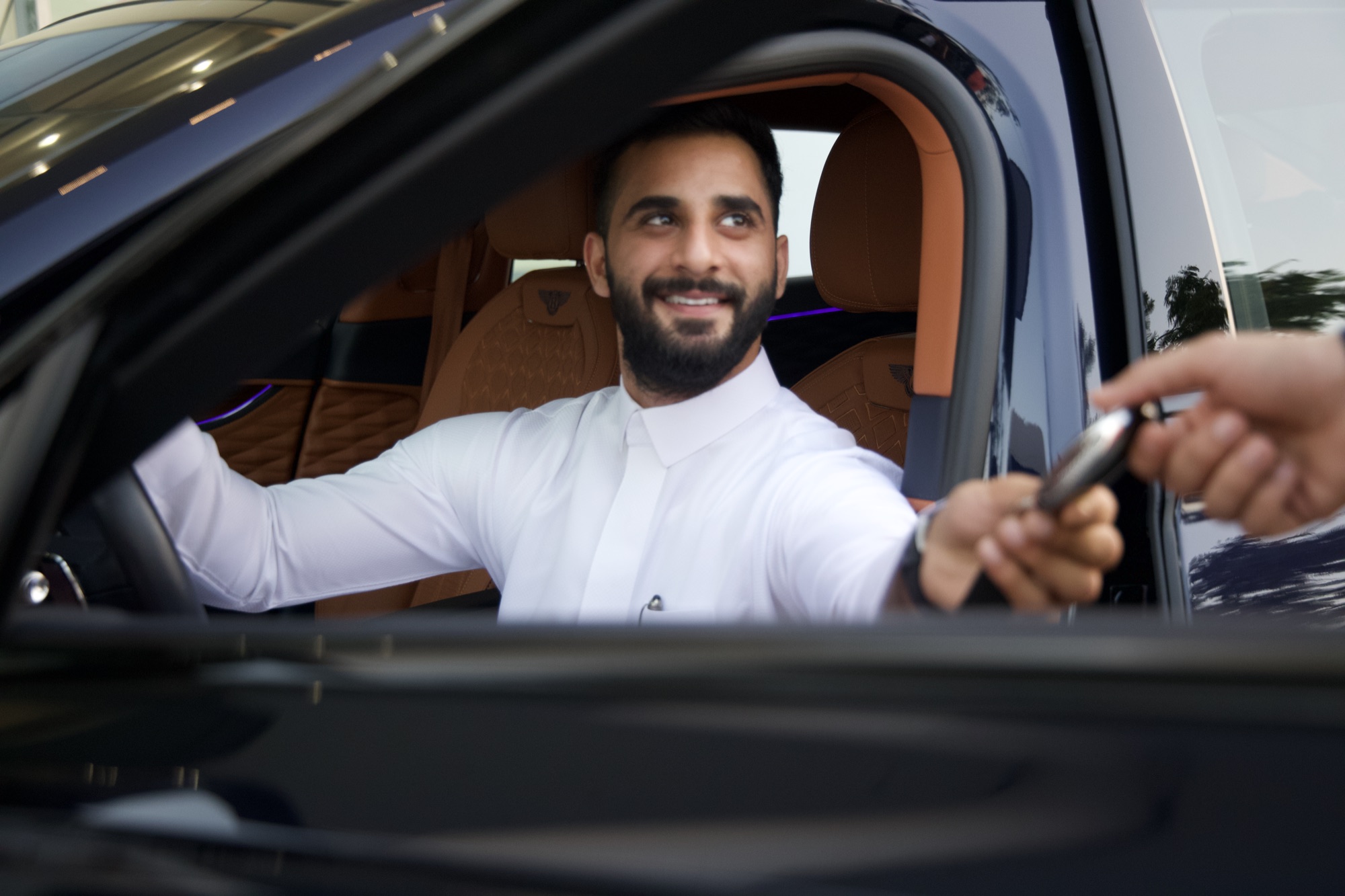 A VPM valet handing keys back to a guest at departure